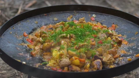 Cooking potatoes with vegetables on a fire close-up Stock Footage 278731220