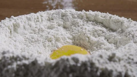 Cooking / Pouring Egg into Flour / Slow Motion Stock Footage 143607693