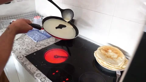 Cooking: Preparing crepes pancake in the kitchen Stock Footage 219613728