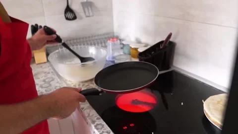 Cooking: Preparing crepes pancake in the kitchen  Stock Footage 219613770