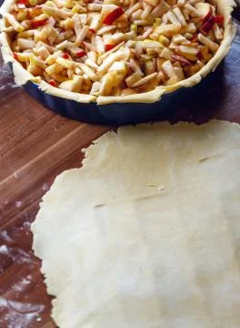 Cooking process of apple pie with shortcrust pastry on wooden desk Stock Photos