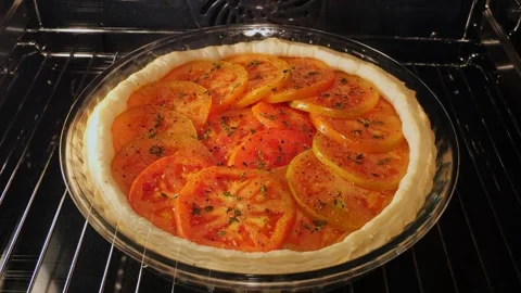 Cooking process baked puff pastry pie tart tomato in oven. Time lapse Stock Footage 252078550