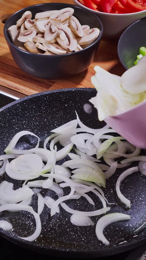 Cooking process beginning, Diced onions added to sizzling oil Video stock 329277435