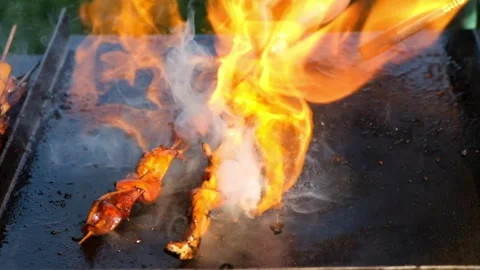 Cooking process Cook grilled squid with a gas grill on a flat pan Stock Footage 274192240