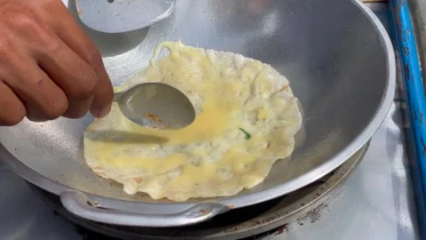 Cooking process of egg martabak street food with spicy seasoning on a frying pan Stock Footage 325977036