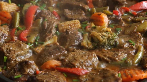 Cooking process frying meat with vegetables close-up on a frying pan recipe Stock Footage 90253643