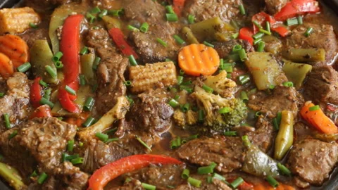 Cooking process frying meat with vegetables close-up on a frying pan recipe Video stock 90253656