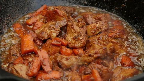 Cooking process, frying pork meat on open fire. Close up, slow motion Stock Footage 131648548