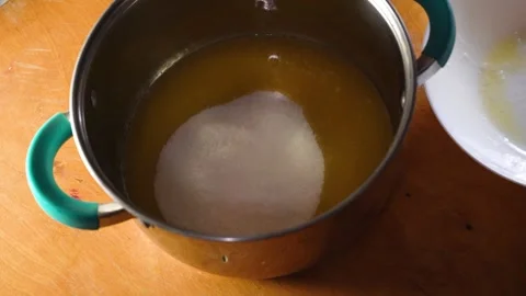 Cooking process. Human hand pour sugar into a bowl, mixing and making dough for Stock Footage 240487086