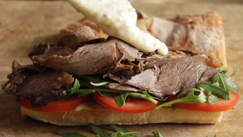 Cooking process making roast beef sandwich with tomato cucumber arugula Video stock 90190115