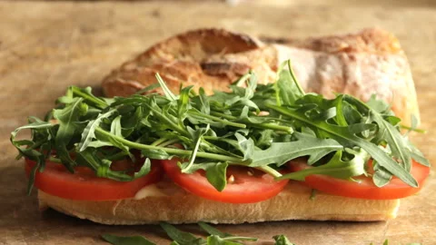 Cooking process making roast beef sandwich with tomato cucumber arugula Stock Footage 90190124