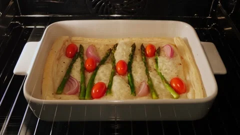 Cooking process puff pastry pie tart asparagus tomato cheese in oven. Time lapse Stock Footage 252078546