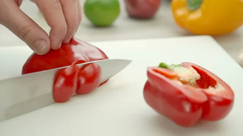 Cooking process. Red bell peppers. Person chopping red bell peppers. Stock Footage