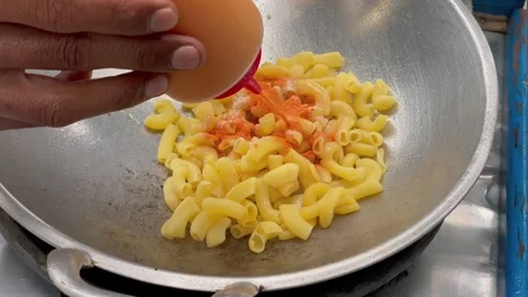Cooking process of spicy wet macaroni street food in a frying pan Stock Footage 325451500