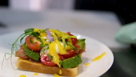 Cooking process Step by step. Pouring sauce on benedict egg with stracciatella Stock Footage 278350948