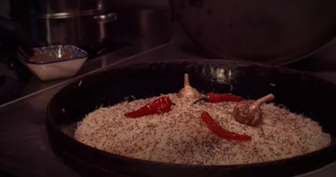The cooking process takes place in a modern kitchen equipped with pots and fresh Stock Footage 297693747