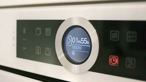 A cooking process is taking place at the high-tech white kitchen. Baking of the Stock Footage 152296042