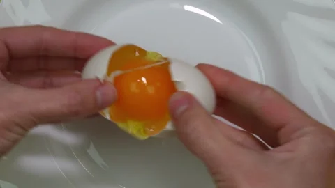 Cooking process. Womens hands break an egg with knife. Stock Footage 309825521