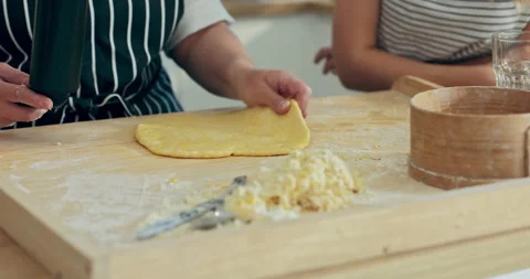 Cooking process young daughter taking some cooking tools helping mother while 動画素材 218667236
