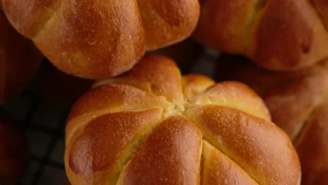 Cooking pumpkin buns. Ready pumpkin buns on a wire rack, close-up. Autumn Stock Footage 141768542