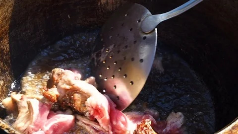 Cooking rabbit roast in a large cauldron Stock Footage 110740558