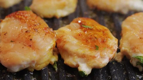 Cooking raw chicken meat in yellow turmeric spice with garlic and greens on Stock Footage 270187931
