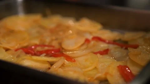 Cooking raw hake fish in oven with paprika, sesame oil, potatoes, onions, garlic 스톡 동영상 136986956