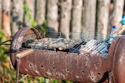 Cooking raw meat in a grid on the barbeque grill Stock Photos