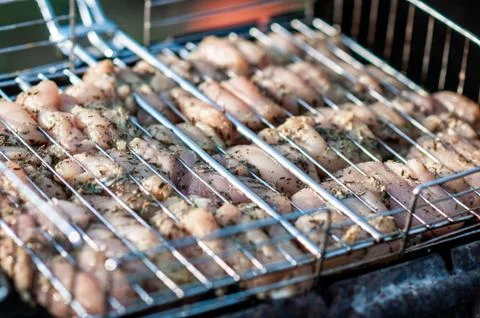 Cooking raw meat in a grid on the barbeque grill Stock Photos