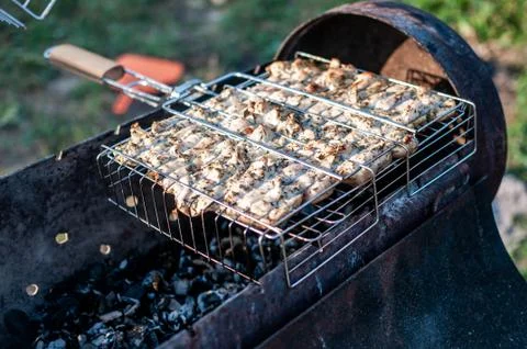 Cooking raw meat in a grid on the barbeque grill Stock Photos
