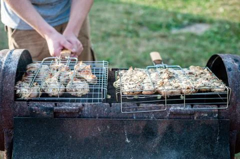 Cooking raw meat in a grid on the barbeque grill Stock Photos
