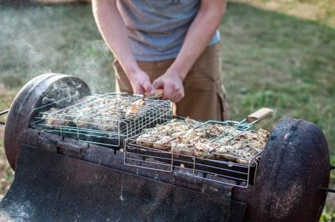 Cooking raw meat in a grid on the barbeque grill Stock Photos