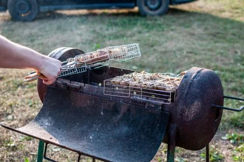 Cooking raw meat in a grid on the barbeque grill Stock Photos