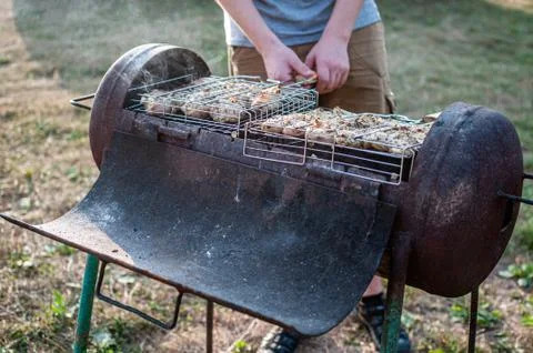 Cooking raw meat in a grid on the barbeque grill Stock Photos