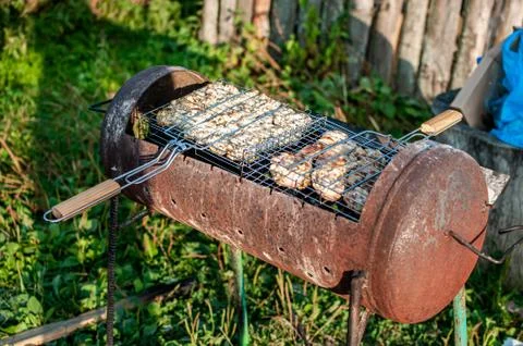 Cooking raw meat in a grid on the barbeque grill Stock Photos