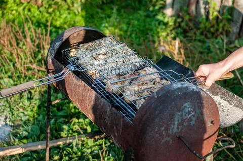 Cooking raw meat in a grid on the barbeque grill Stock Photos