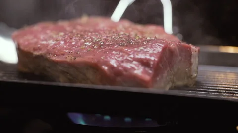 Cooking raw steak Stock Footage