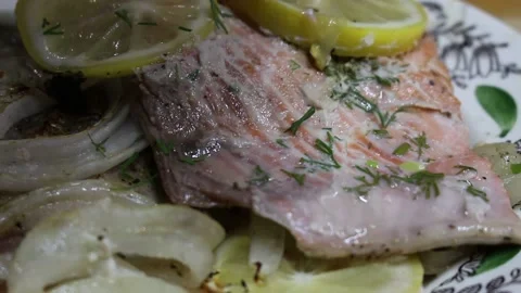 Cooking red fish on fire with lemon and onion and herbs Stock Footage 134199065