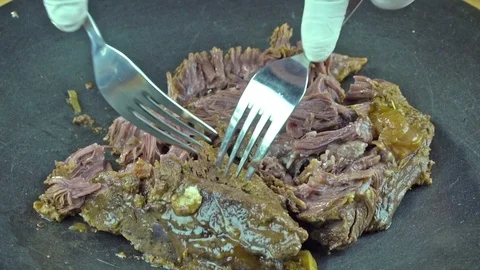 Cooking red meat on pan with vegetables. Turkish kebab cutting with fork. Stock Footage 76418749