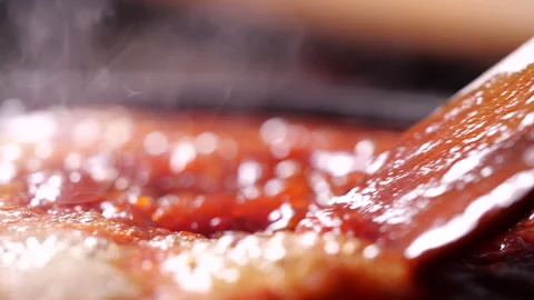 Cooking red tomato sauce in a boiling pan and stirring with steam Stock Footage 130931847