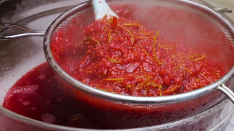 Cooking redcurrant jam process of mashing berries through a metal sieve. 動画素材 337674736