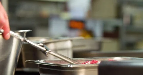 Cooking on restaurant kitchen 4k video. Raw meat bone steak, chef food tongs Stock Footage 70005232