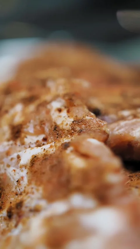 Cooking. ribs in spices. close-up. Raw Pork ribs with a spices for BBQ. meat is Stock Footage 320959259