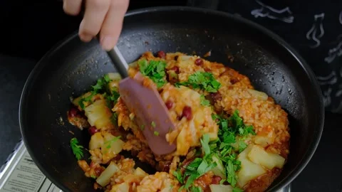 Cooking Rice and Beans in a Black Pan with Spatula Stock Footage 341432974