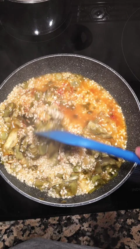 Cooking risotto with artichokes. Stock Footage 345152172