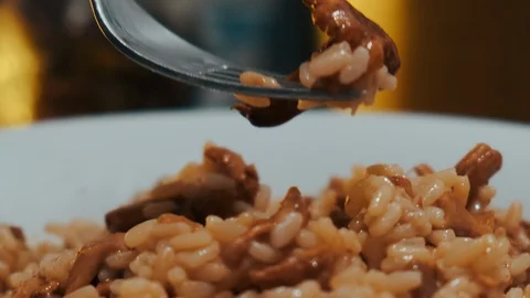 Cooking risotto with chanterelle mushrooms Stock Footage 129512840