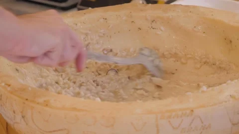 Cooking risotto in parmesan cheese bowl, italian cuisine concept. Chef preparing 스톡 동영상 172556670