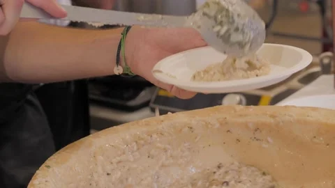 Cooking risotto in parmesan cheese bowl, italian cuisine concept. Chef preparing Stock Footage 172556729