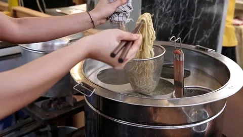 Cooking rubber noodles using a noodle strainer Video stock 272297918