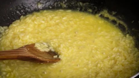 Cooking a saffron risotto in a pan Stock Photos
